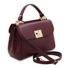 Angled And Shoulder Strap View Of The Bordeaux Designer Handbag