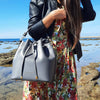 Women Posing With The Grey Leather Bucket Bag